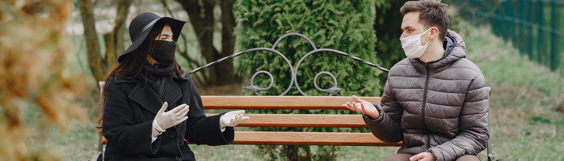people-talking-at-bench-masks-social-distancing
